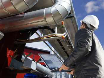 Technician assessing energy solution system